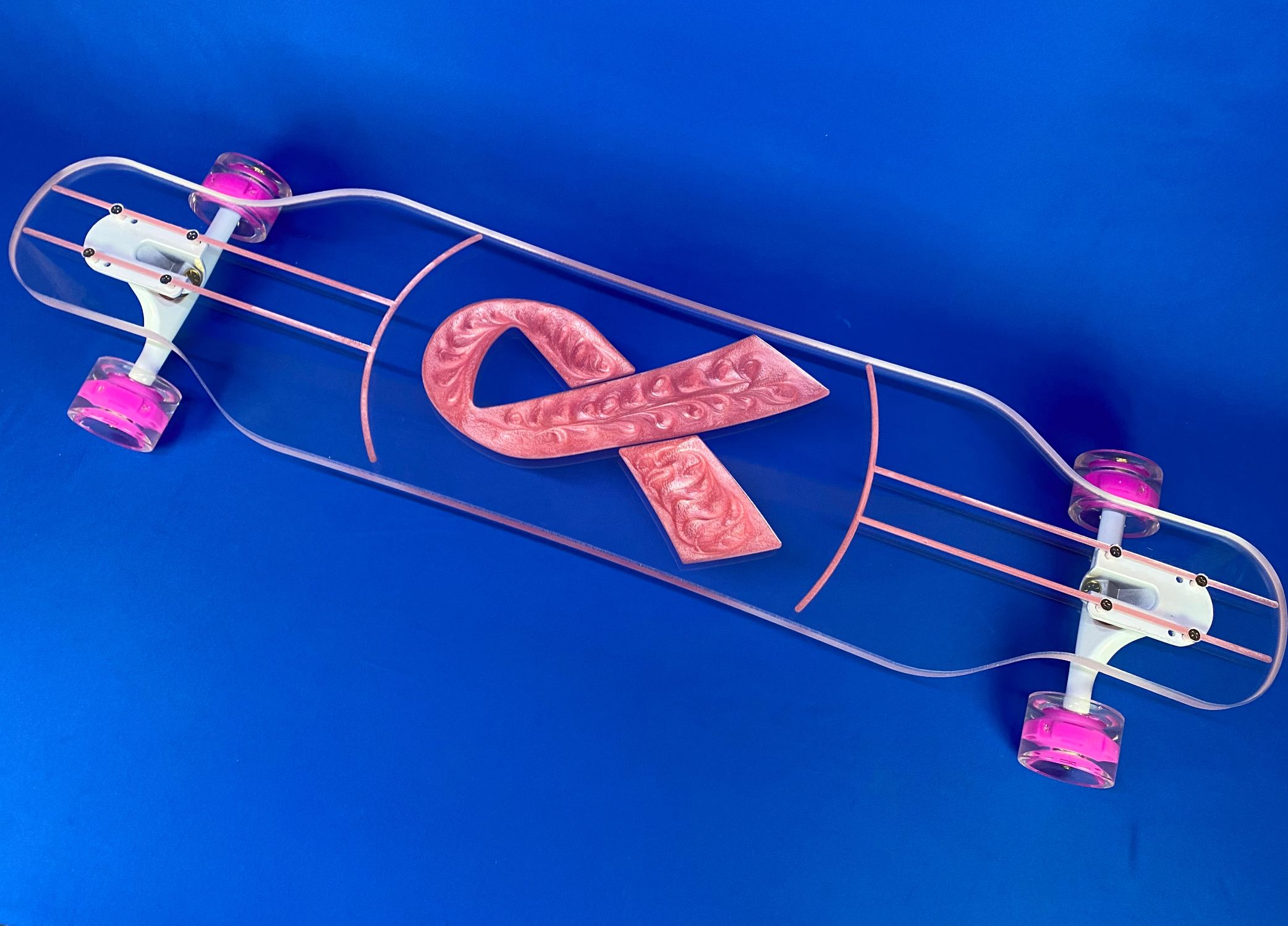Breast cancer awareness ribbon desing filled with pink and white resin swirled in this clear custom longboard by Ghost Boards
